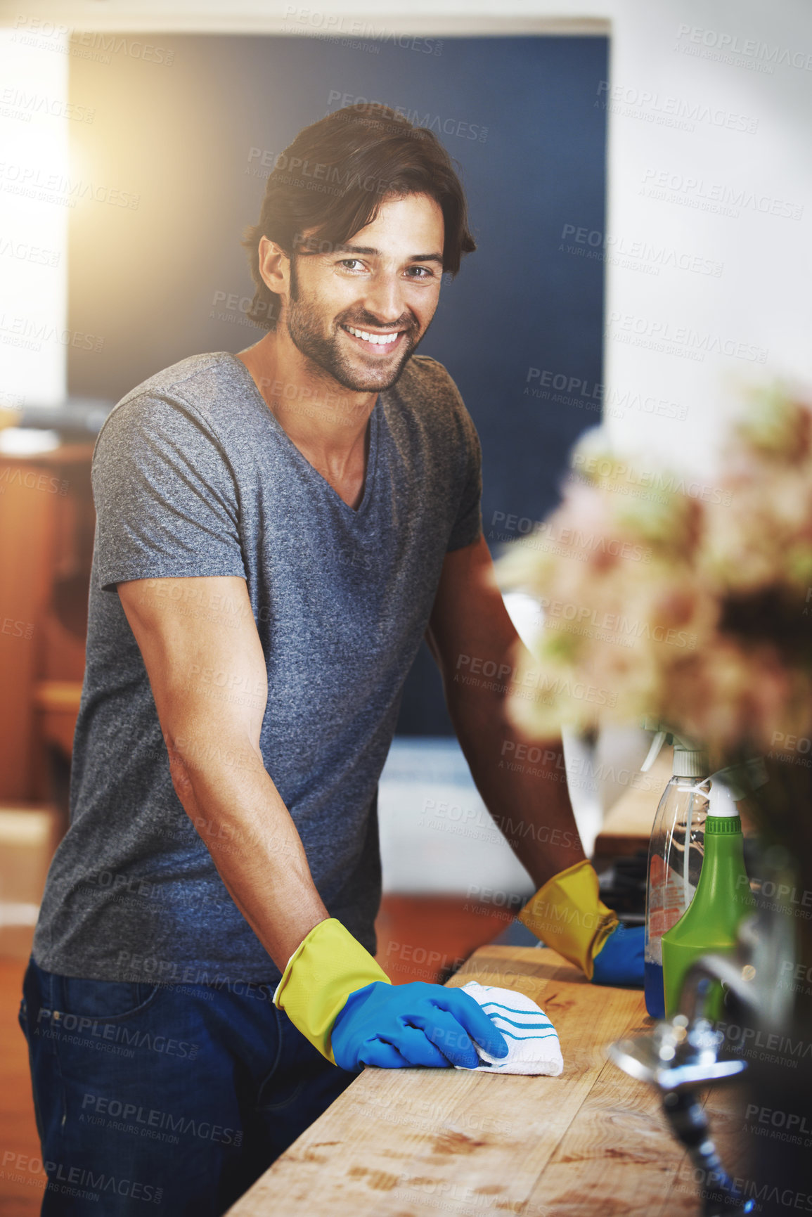 Buy stock photo Portrait of a young man cleaning the house