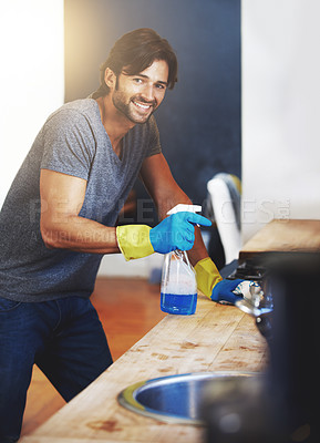 Buy stock photo Shot of a young man cleaning the house