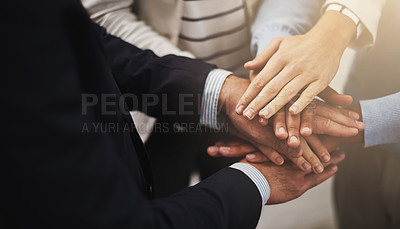 Buy stock photo Cropped shot of a group of businesspeople putting their hands together in unity