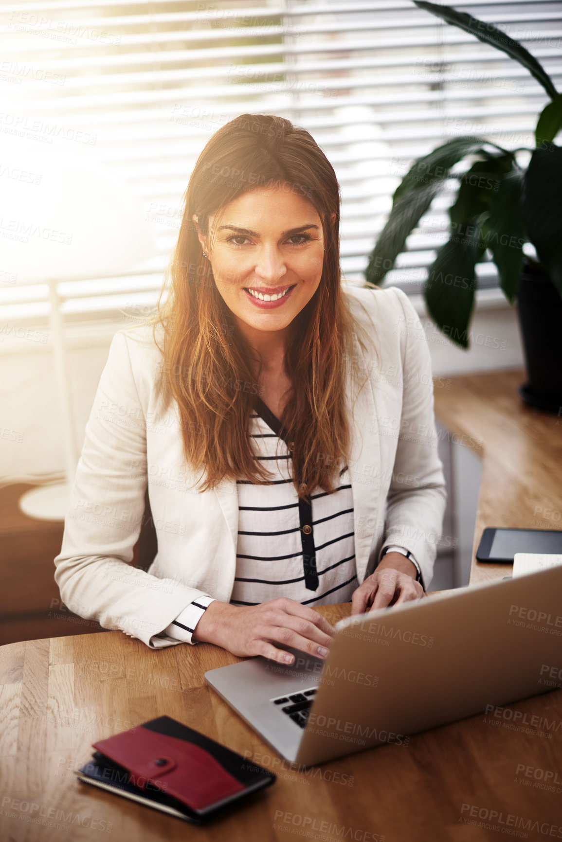 Buy stock photo Happy, laptop and portrait of business woman in office for communication, email or search web. Lens flare, professional and employee with computer for planning, agenda or typing report in workplace