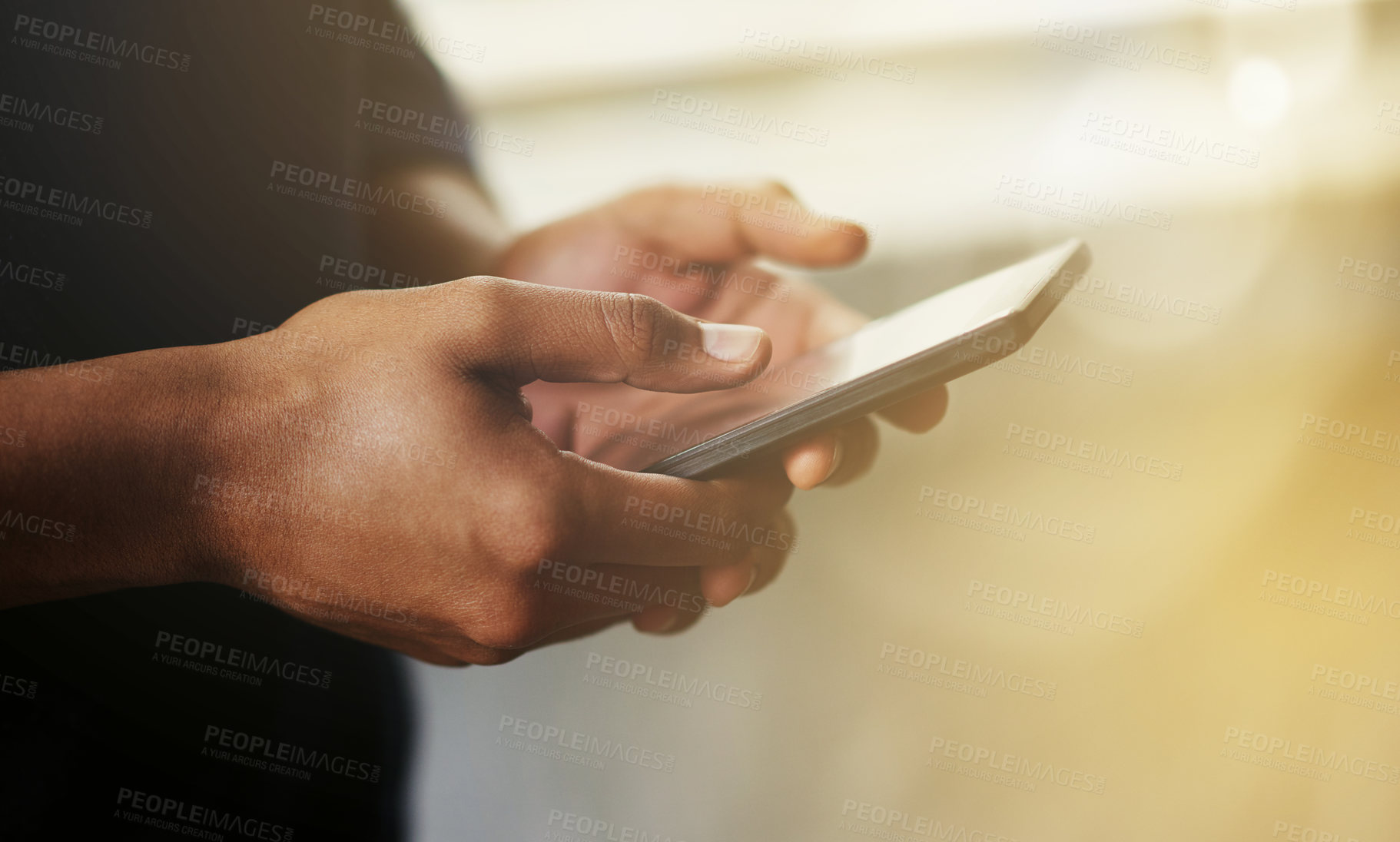 Buy stock photo Cropped shot of a man using a smartphone