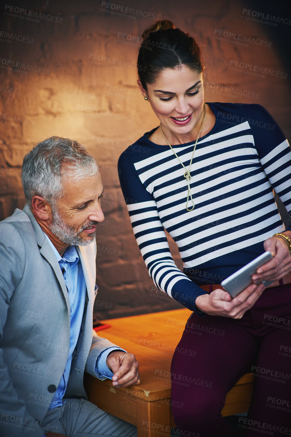 Buy stock photo Tablet, collaboration or planning with mentor and employee at desk in office together for feedback. Manager, review and training with business people in dark workplace for research or online report