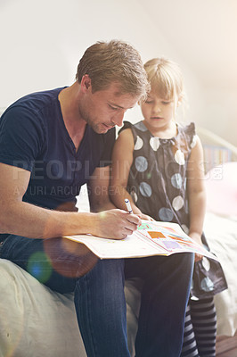 Buy stock photo Shot of a single dad helping his daughter with her homework