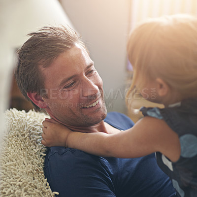 Buy stock photo Shot of a single dad hugging his daughter at home