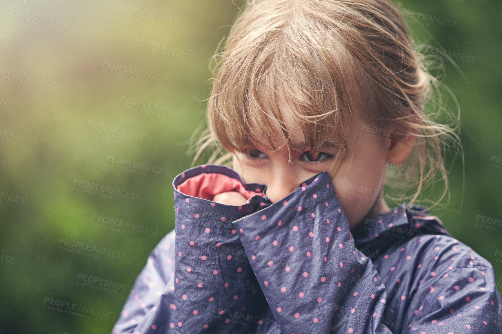 Buy stock photo Shot of a shy little girl standing outside