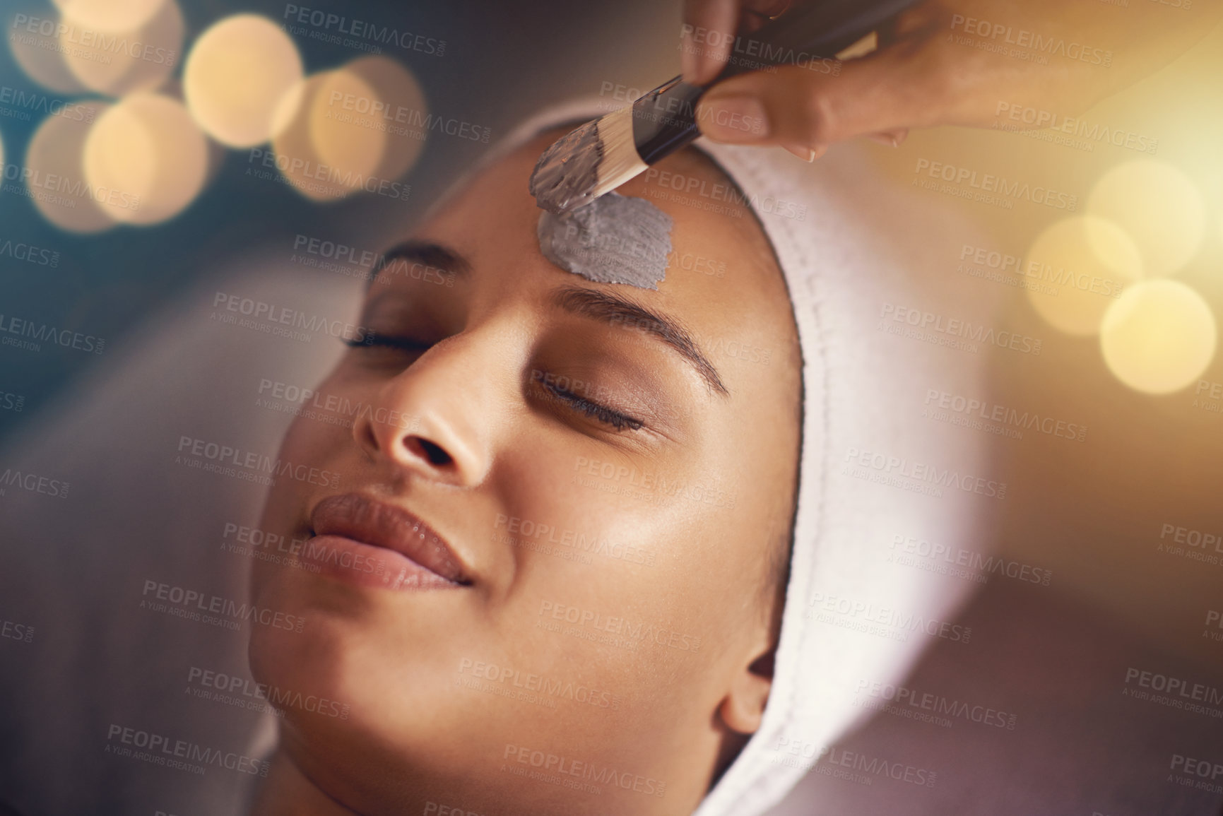 Buy stock photo Woman, relax and wellness in spa for facial, therapy and cosmetic treatment with eyes closed for break and skincare. Young person with towel on head for clay mask, holistic and hygiene for beauty