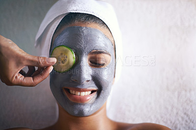 Buy stock photo Woman, face mask and smile with hands and cucumber for facial, spa wellness and beauty treatment. Above, towel and calm female person with skincare and relax at hotel with glow and cosmetic cream