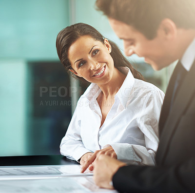 Buy stock photo Cropped shot of two colleagues working together in an office