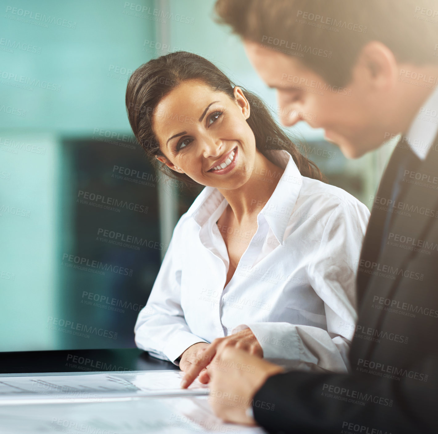 Buy stock photo Cropped shot of two colleagues working together in an office