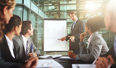 Buy stock photo Cropped shot of a group of businesspeople listening to a presentation