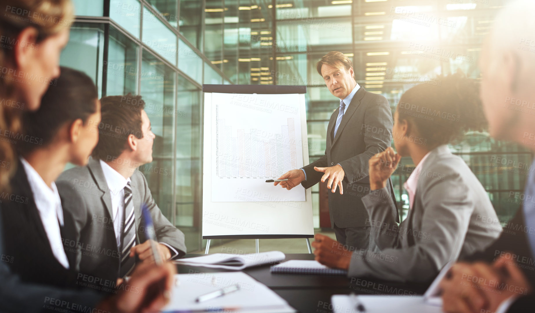 Buy stock photo Cropped shot of a group of businesspeople listening to a presentation