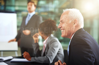 Buy stock photo Cropped shot of a group of businesspeople listening to a presentation