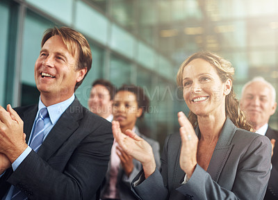 Buy stock photo Cropped shot of a group of businesspeople applauding while sitting in a presentation