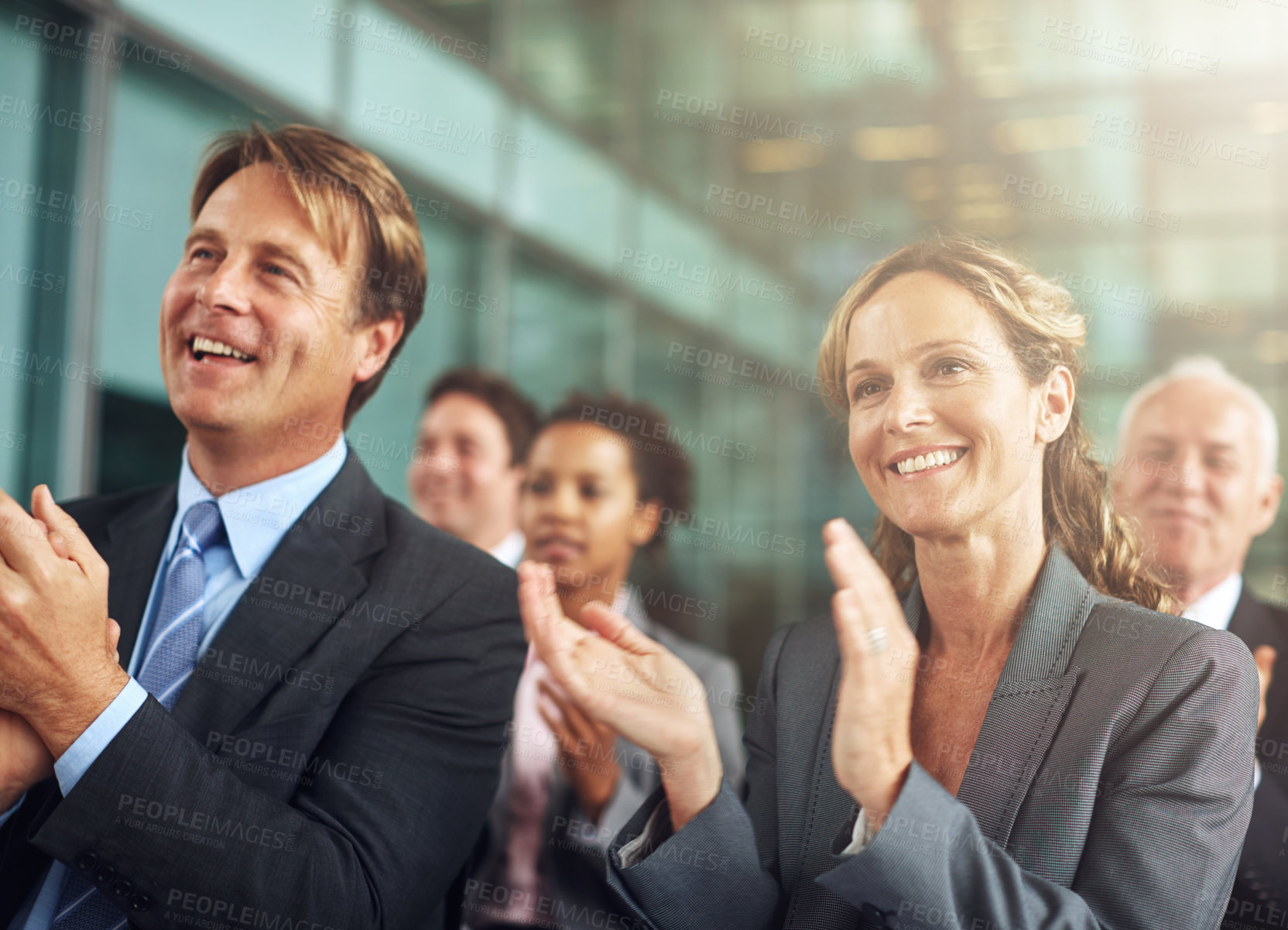 Buy stock photo Cropped shot of a group of businesspeople applauding while sitting in a presentation