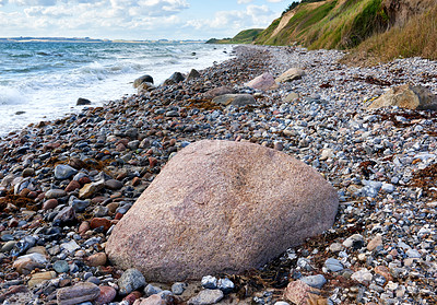 Buy stock photo Coast of Kattegat - Helgenaes, Denmark. Ocean waves washing onto empty beach shore stones. Calm peaceful paradise of summer seascape and sky for relaxing fun holiday abroad or travel vacation