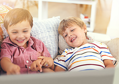 Buy stock photo Shot of two little boys using a laptop together