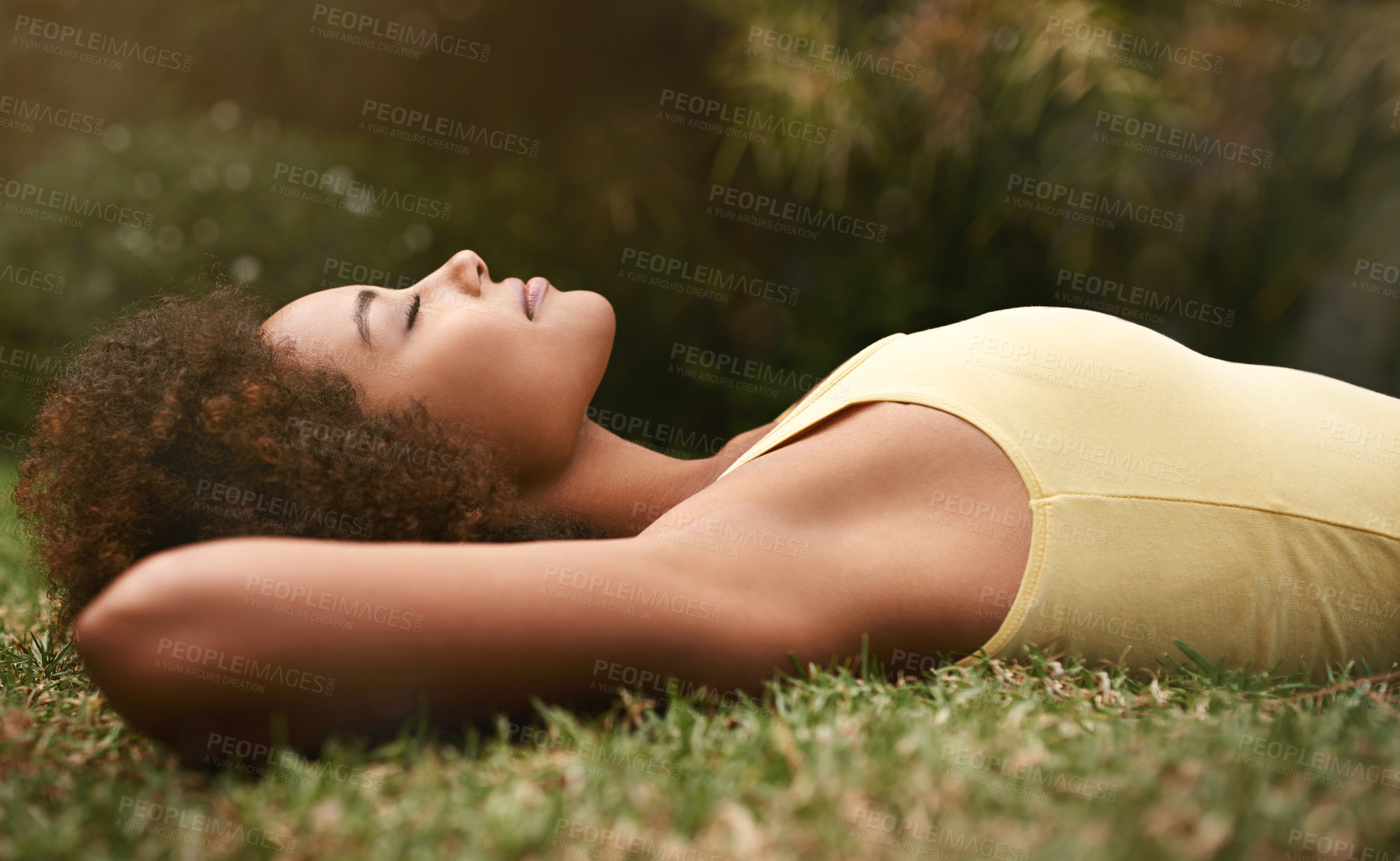 Buy stock photo Dreaming, grass and mockup with a black woman lying on a field for peace or quiet in nature during the day. Sleeping, relax and zen with an attractive young female resting alone in the countryside