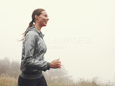 Buy stock photo Nature, energy and woman running in fog on mountain road for race, marathon or competition training. Sports, exercise and athlete with cardio workout for fitness in misty outdoor woods or forest.