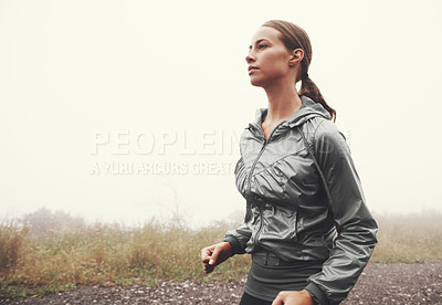 Buy stock photo Nature, wellness and young woman running on mountain road for race, marathon or competition training. Sports, exercise and female athlete with cardio workout in misty outdoor woods or forest.