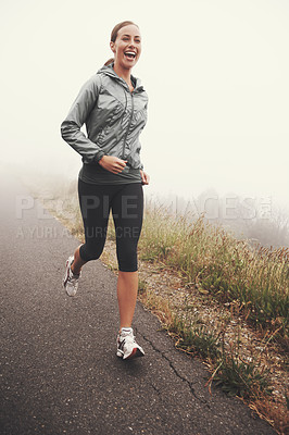 Buy stock photo Happy, woman and running on road outdoor in forest, park or woods for exercise in winter. Morning, fog and person with fitness training and healthy workout on path in mountain countryside with smile