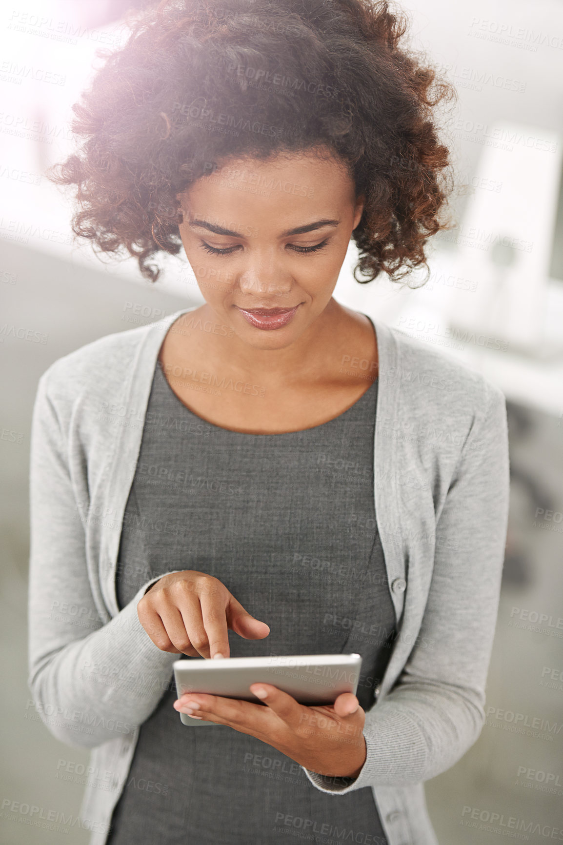 Buy stock photo Cropped shot of a young businesswoman using her tablet in the office