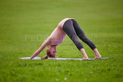 Buy stock photo Shot of a woman doing yoga in the park