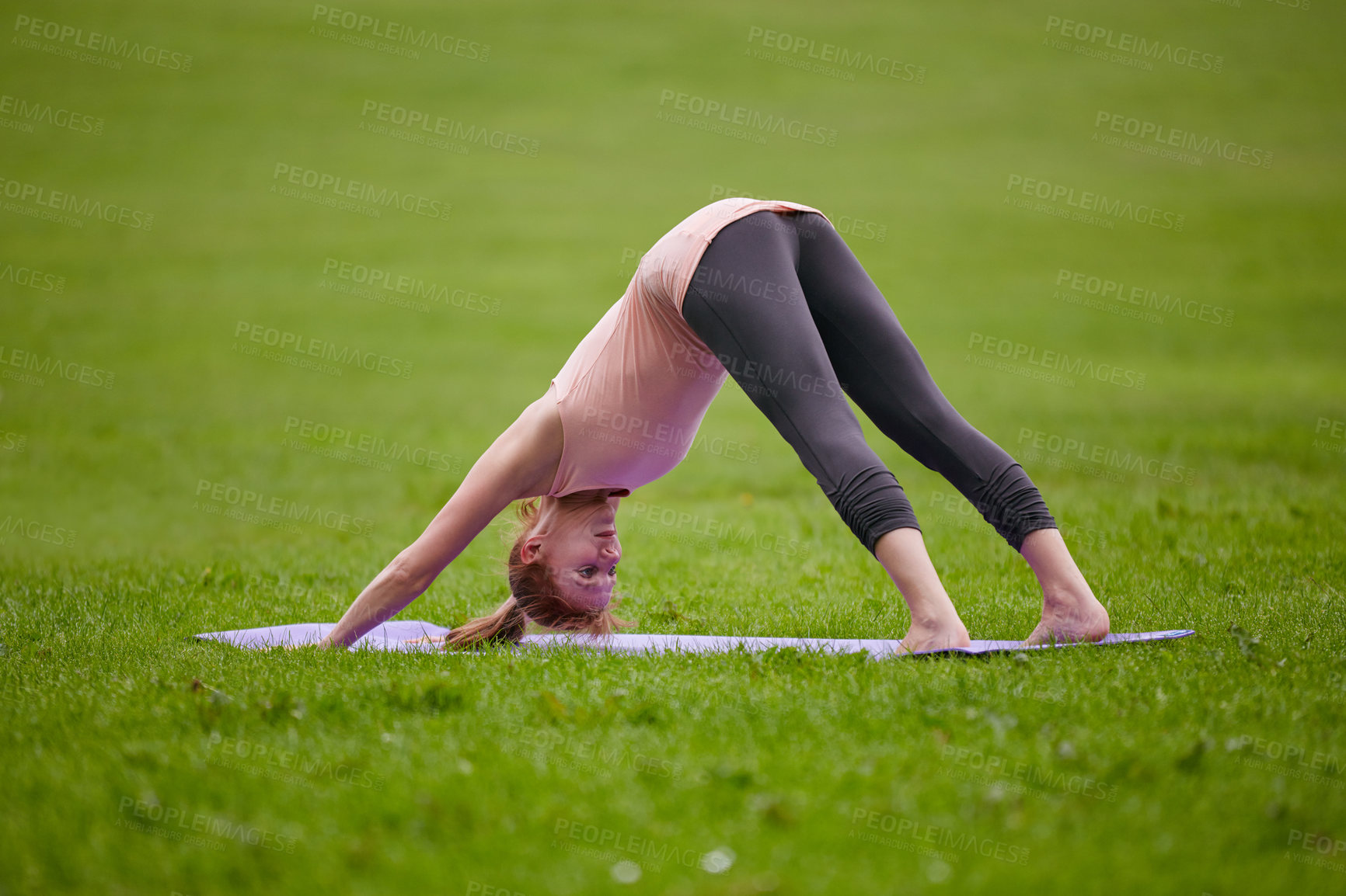 Buy stock photo Shot of a woman doing yoga in the park