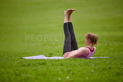 Buy stock photo Shot of a woman doing yoga in the park