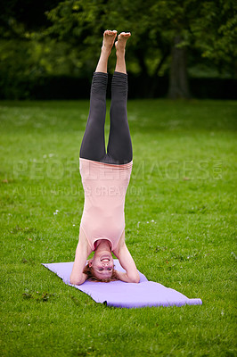 Buy stock photo Shot of a woman doing yoga in the park