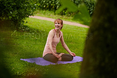 Buy stock photo Shot of a woman doing yoga in the park