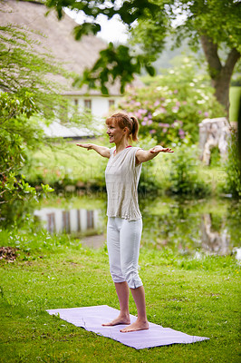 Buy stock photo Shot of a woman doing yoga in the park