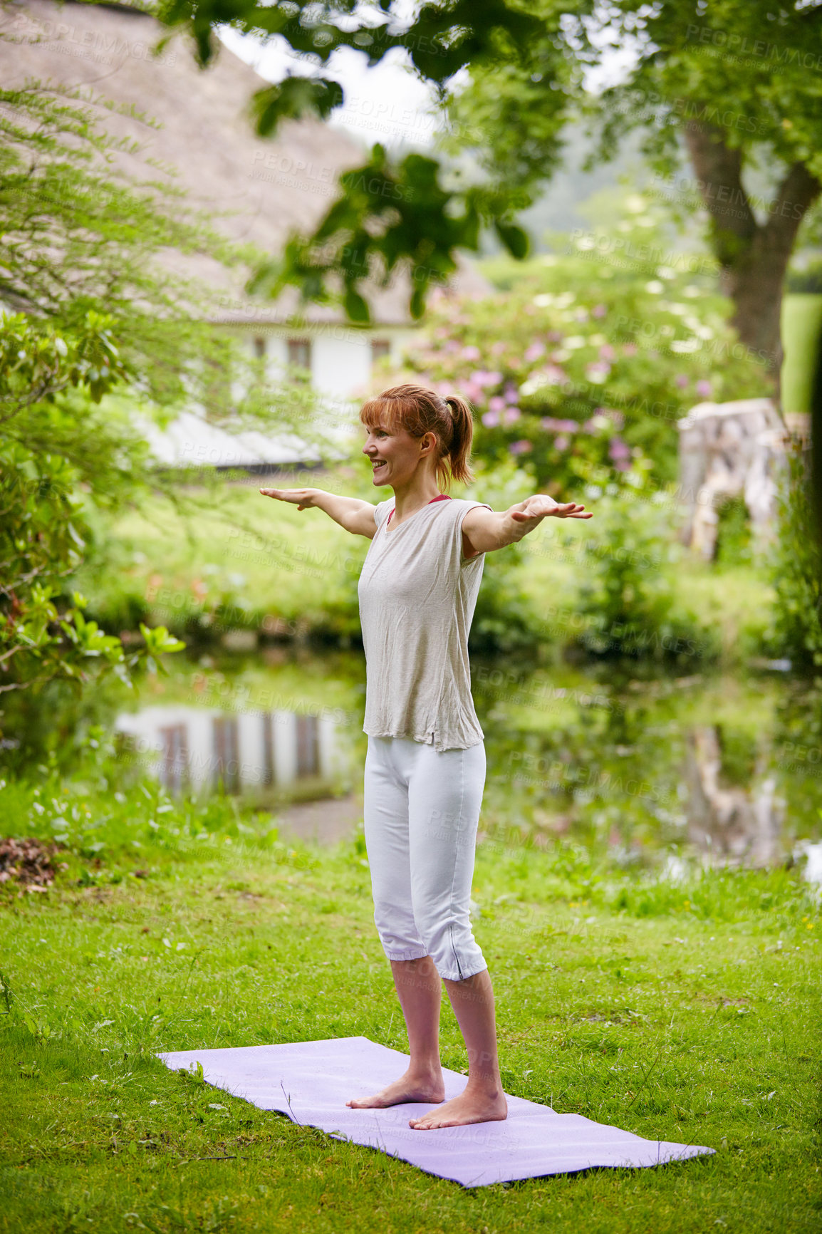 Buy stock photo Shot of a woman doing yoga in the park