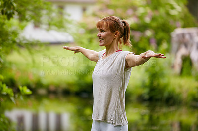 Buy stock photo Shot of a woman doing yoga in the park