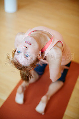 Buy stock photo Shot of a woman doing a backbend during a yoga workout