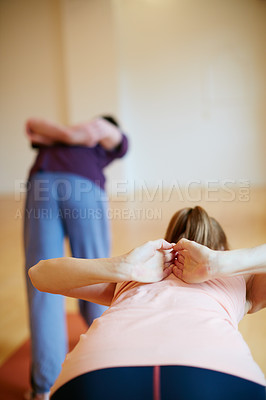 Buy stock photo Shot of two people doing yoga together in a studio