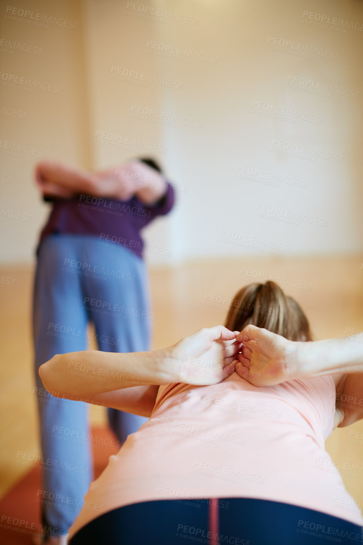 Buy stock photo Shot of two people doing yoga together in a studio