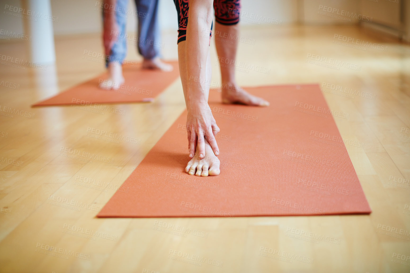 Buy stock photo Cropped shot of people's legs as they're doing yoga indoors