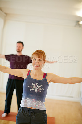 Buy stock photo Shot of two people doing yoga together indoors