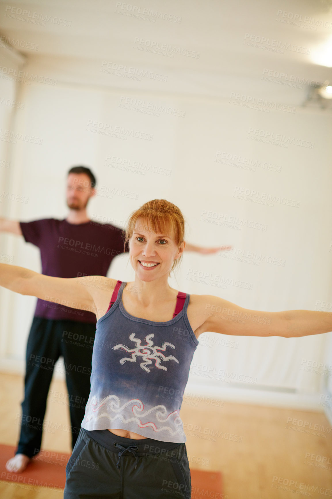 Buy stock photo Shot of two people doing yoga together indoors