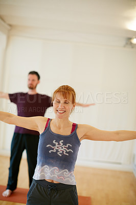 Buy stock photo Shot of two people doing yoga together in a studio