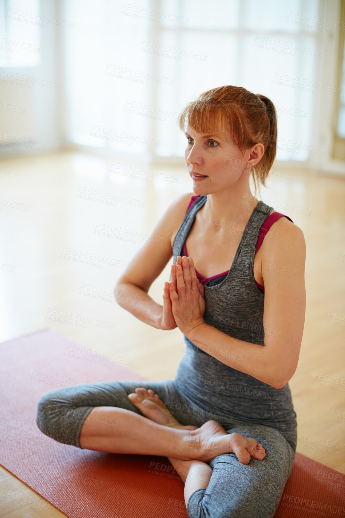 Buy stock photo Shot of a woman doing yoga indoors