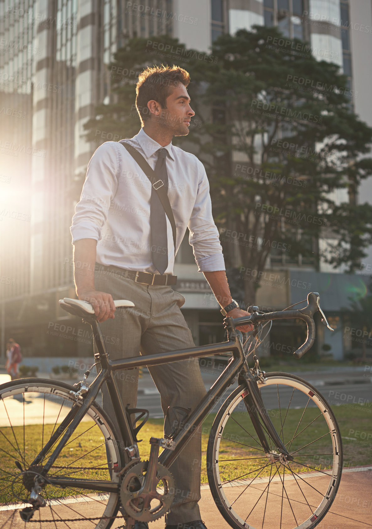 Buy stock photo Shot of a businessman commuting to work with his bicycle