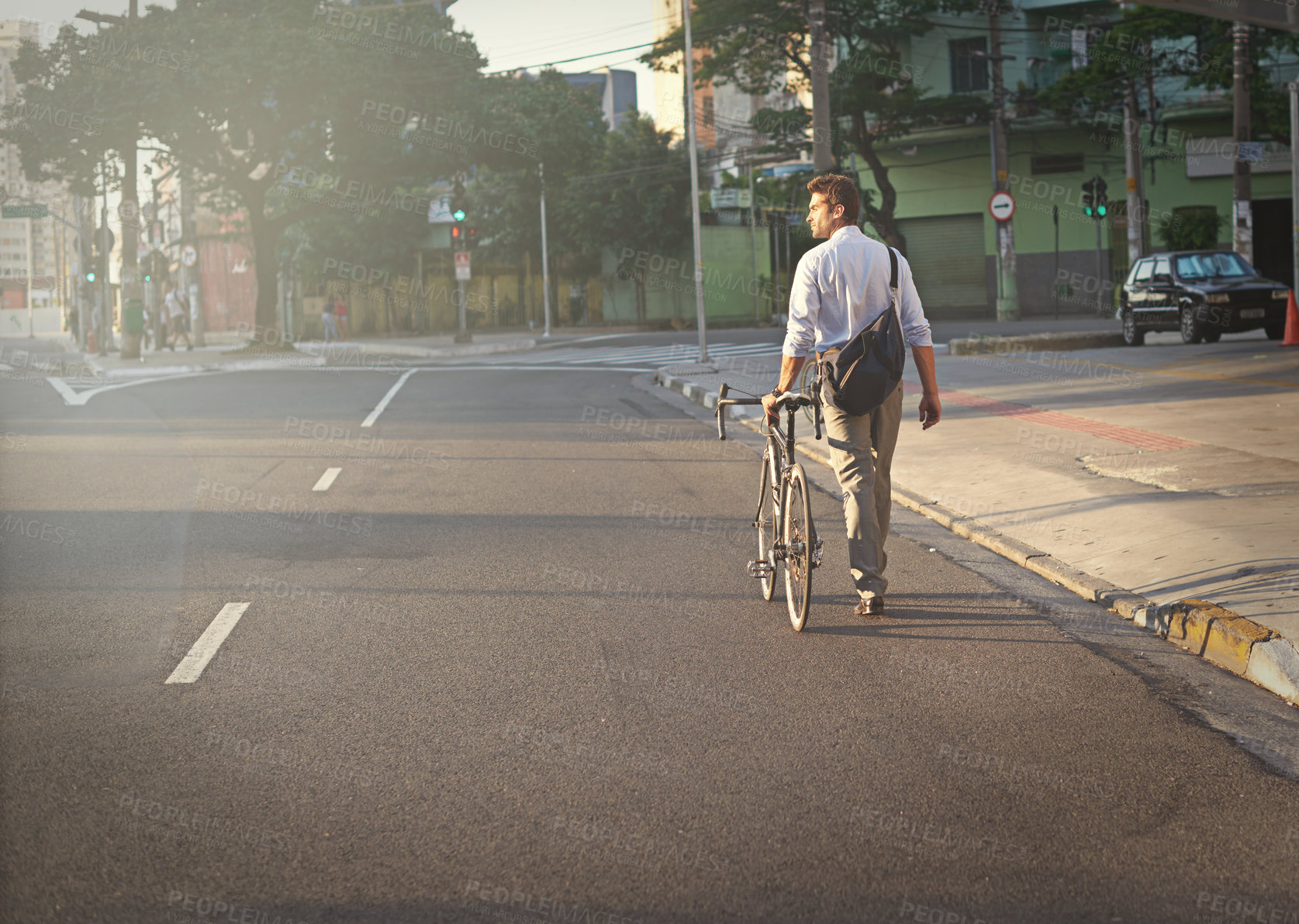 Buy stock photo Shot of a businessman commuting to work with his bicycle
