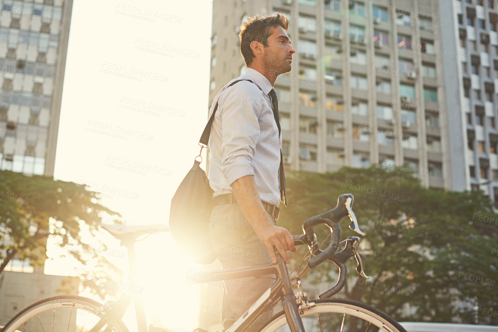 Buy stock photo Shot of a businessman commuting to work with his bicycle