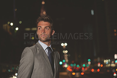 Buy stock photo A handsome businessman in the city at night