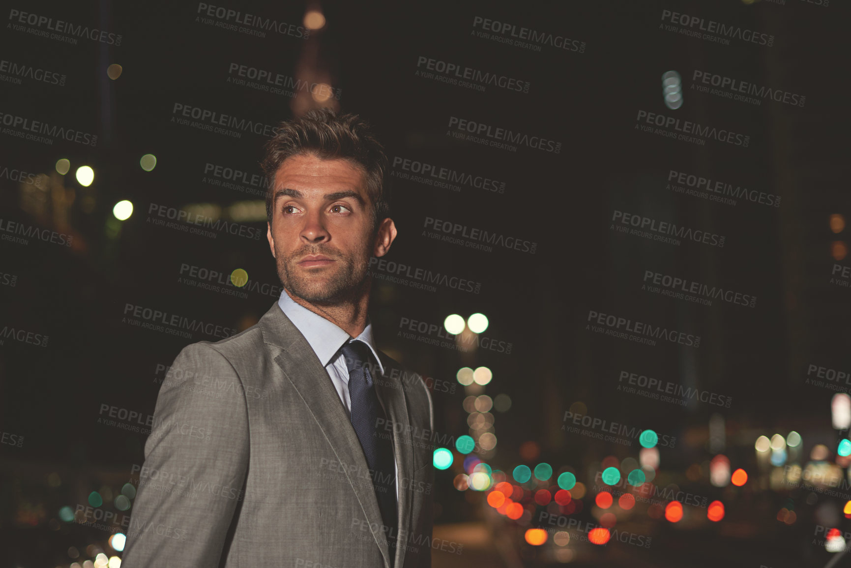 Buy stock photo A handsome businessman in the city at night