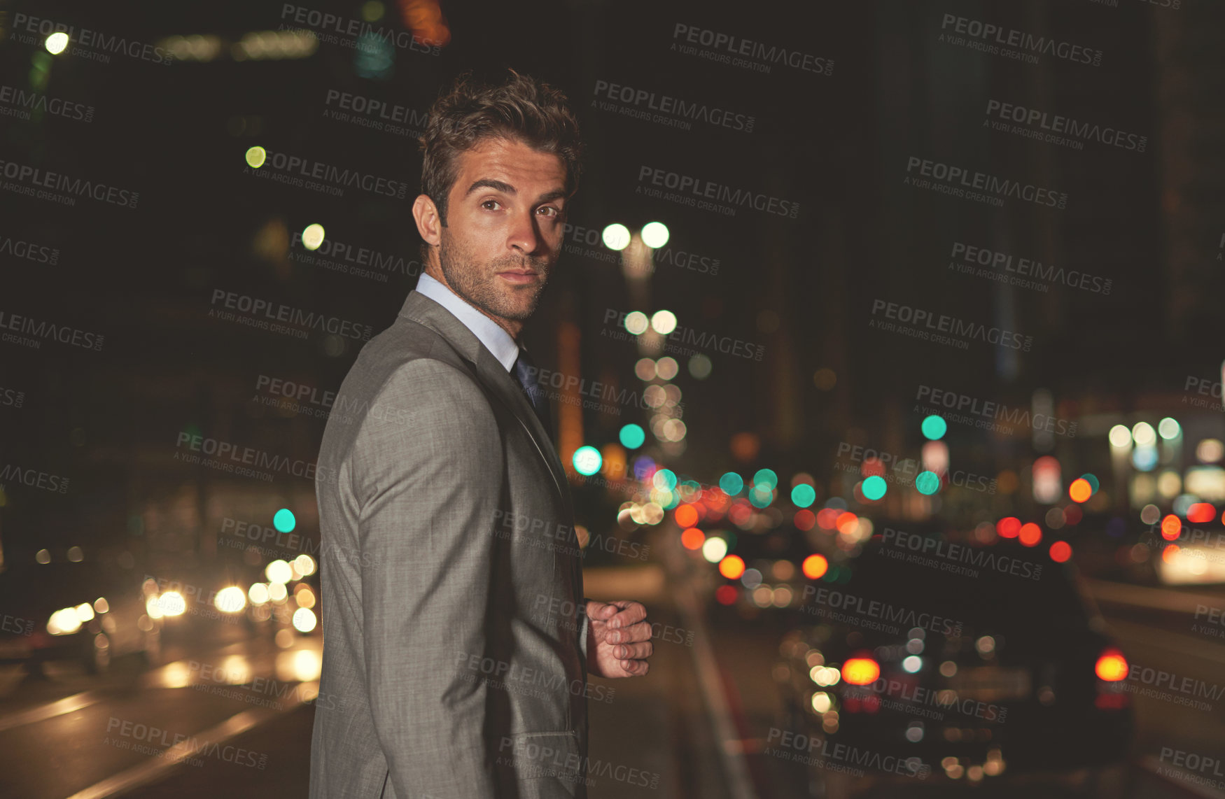 Buy stock photo A handsome businessman in the city at night