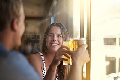 Buy stock photo Toast, happy couple and drink beer in pub at party for celebration, relax and leisure together in restaurant. Smile, man and woman cheers with alcohol, beverage or glass at bar on a date at club