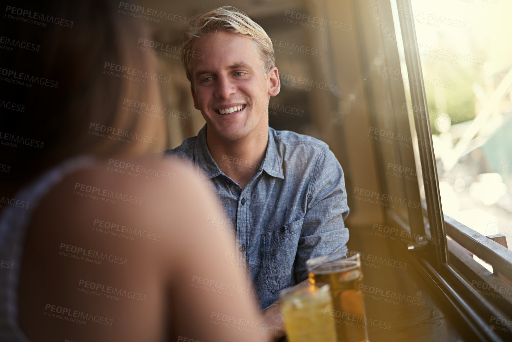 Buy stock photo Conversation, happy couple and drinking beer in pub, relax and leisure together in restaurant with alcohol. Smile, man and woman talk at bar for connection, relationship or bonding on a date at club