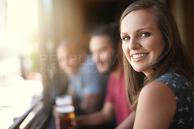 Buy stock photo Portrait, smile and a woman at pub to relax, cheerful or positive facial expression for leisure at restaurant. Face, bar or happy female person or young customer in casual clothes at cafe for alcohol